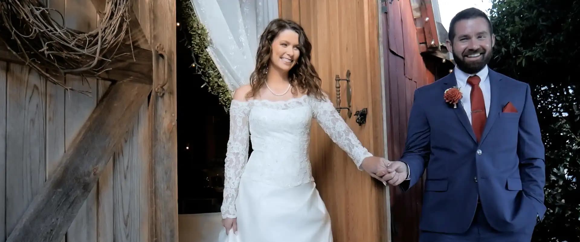 H + J holding hands smiling the moment before the bride reveals herself to the groom for the first look.