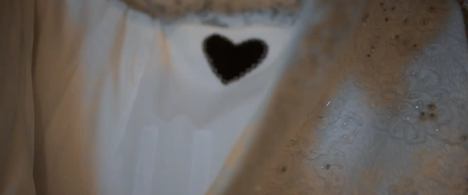 The bride's dress showing a black heart sewn into the dress. The heart is an important detail about the bride's late father.