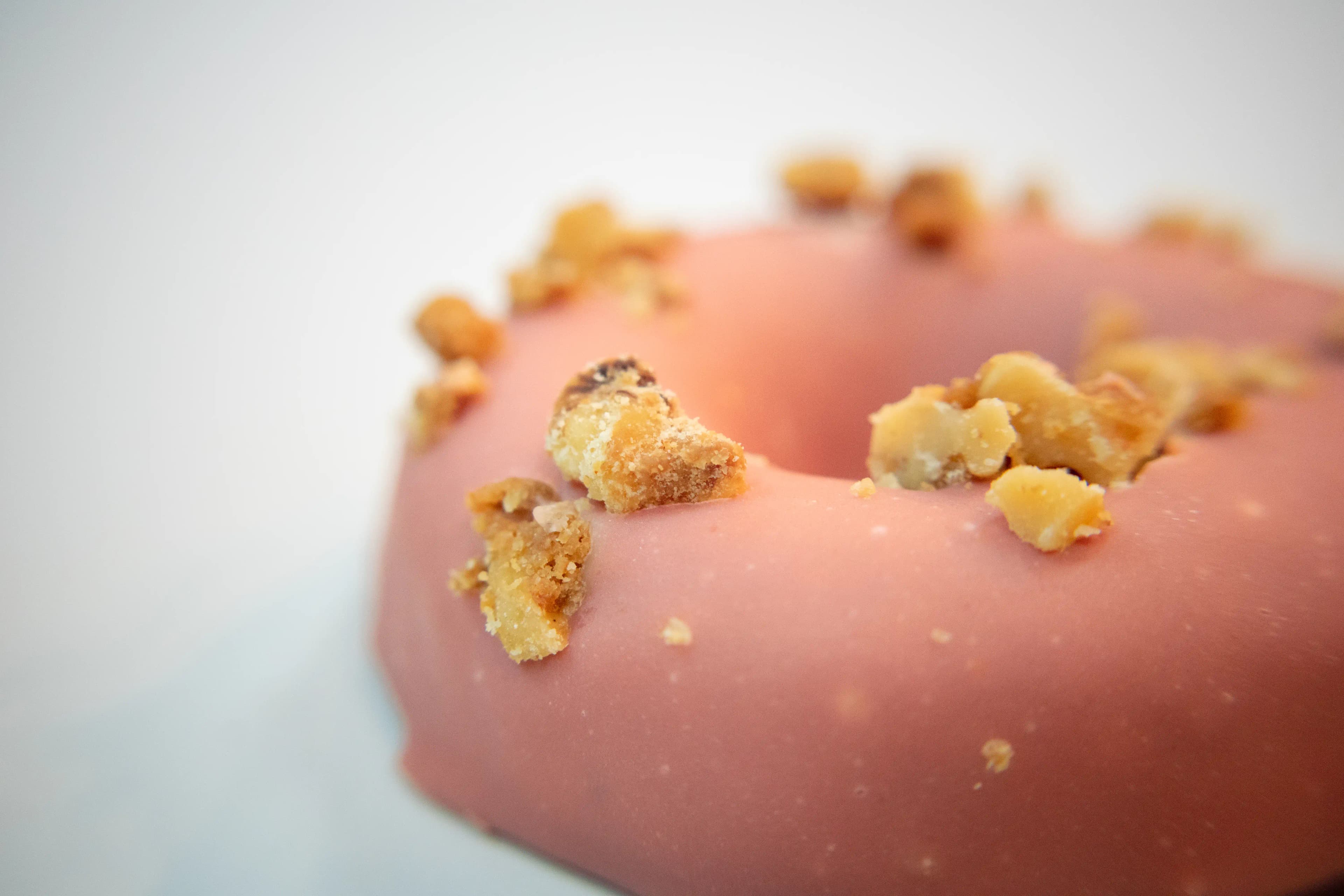 A close-up photo of Rotten Apples Canna Co.'s Maple Covered Bourbon Donut.