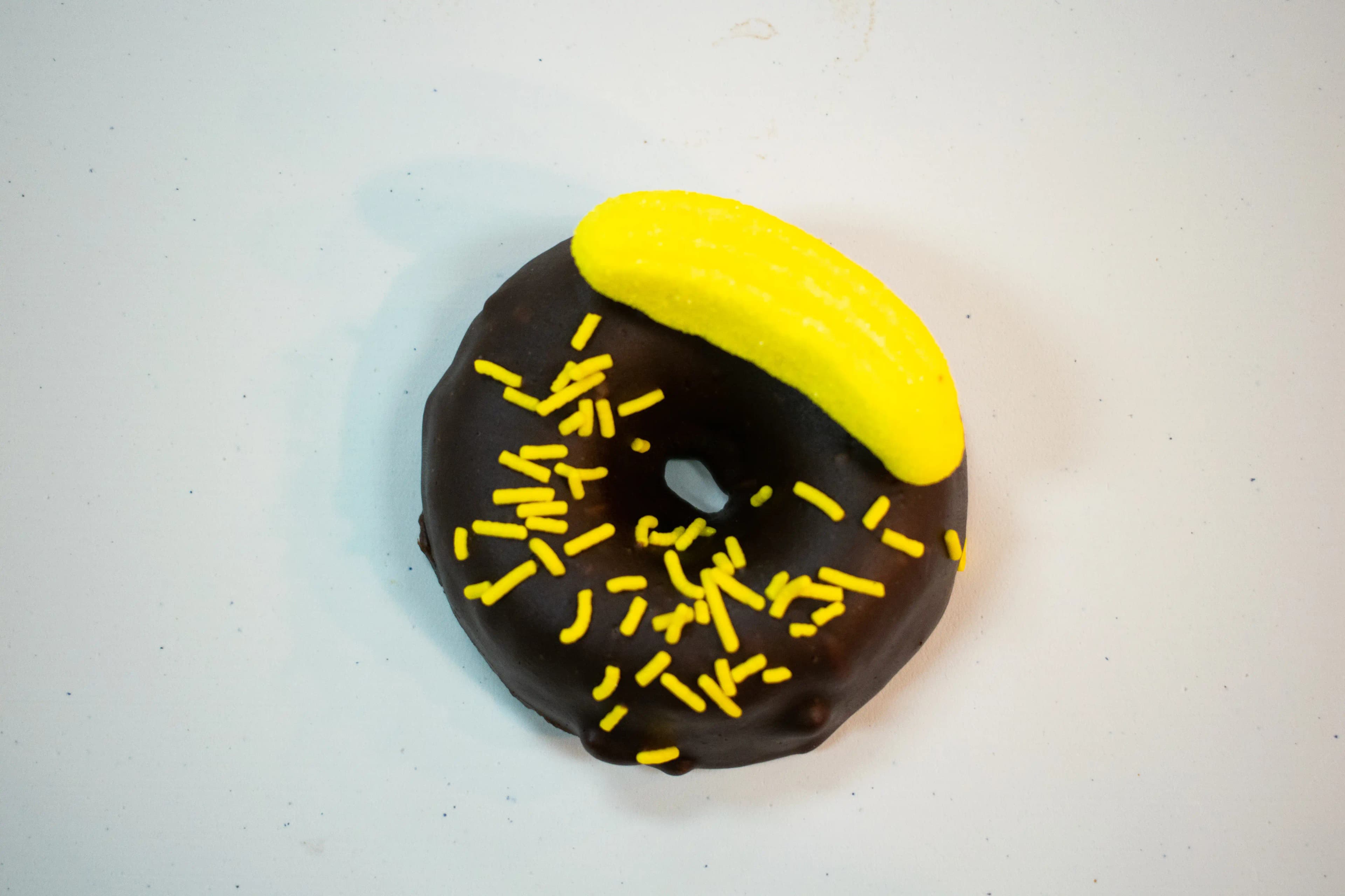 A top-down photo of Rotten Apples Canna Co.'s Chocolate Covered Banana Nut Donut.