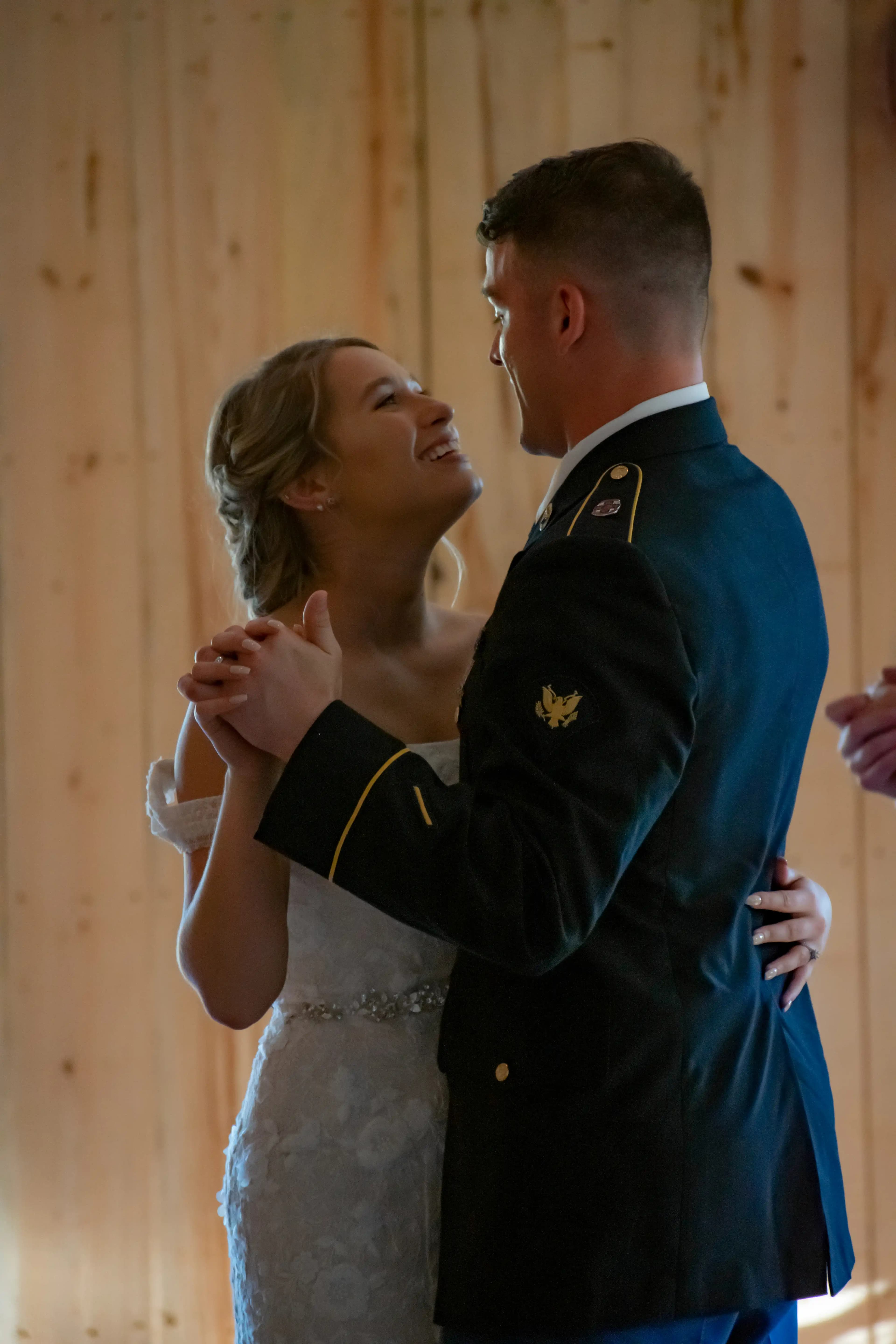 The bride smiling at her new husband during their first dance.