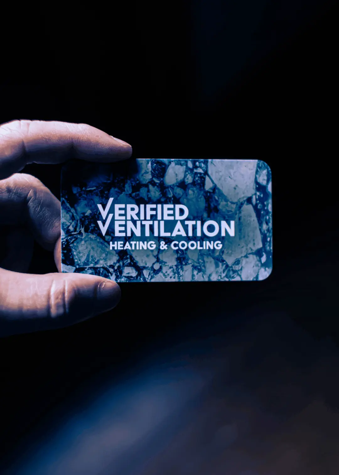 an animated image showing the Verified Ventilation business card transitioning from the front side of the card to the back side of the card. Details have been blurred for employee privacy.