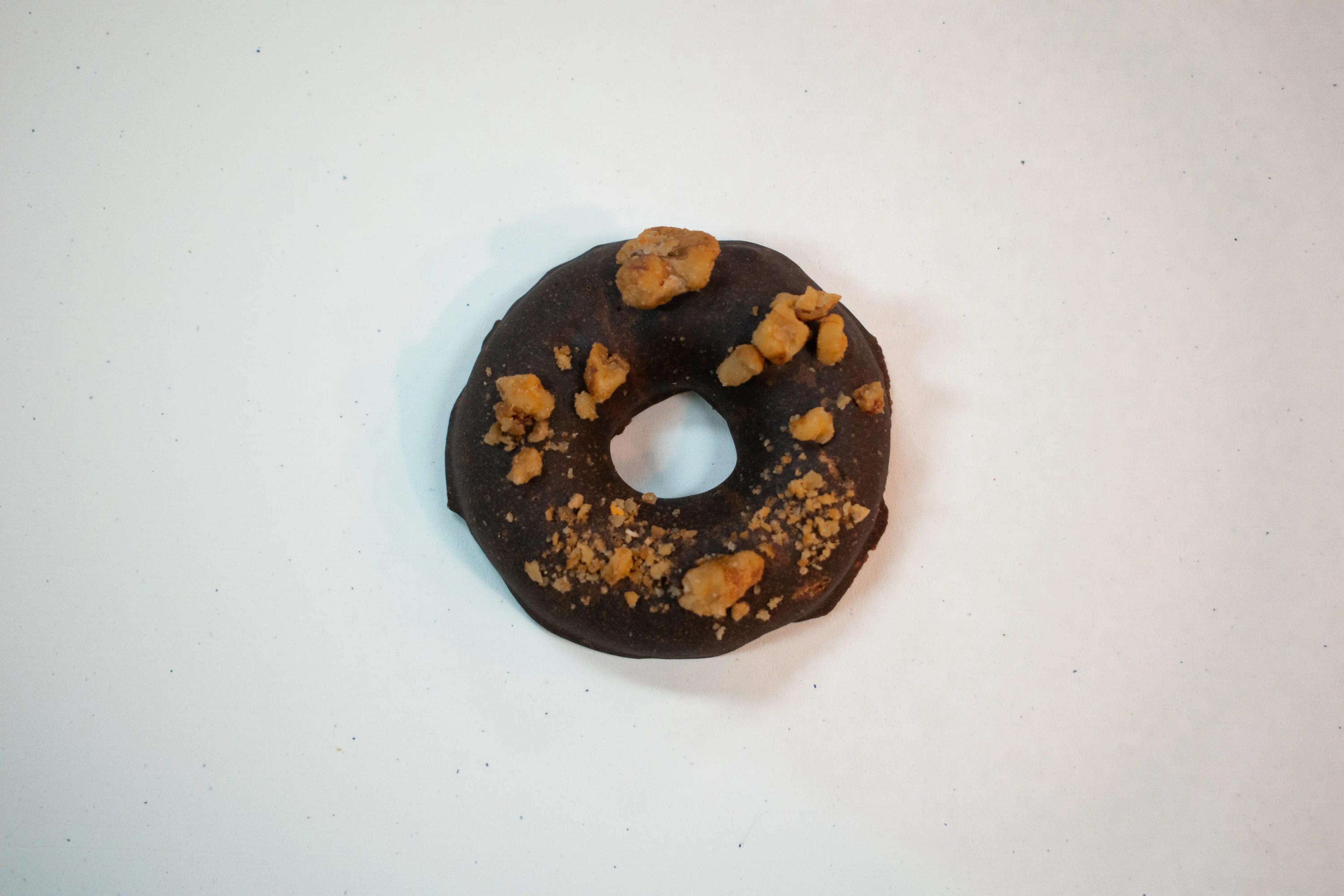 A top-down photo of Rotten Apples Canna Co.'s Chocolate Covered Bourbon Donut.