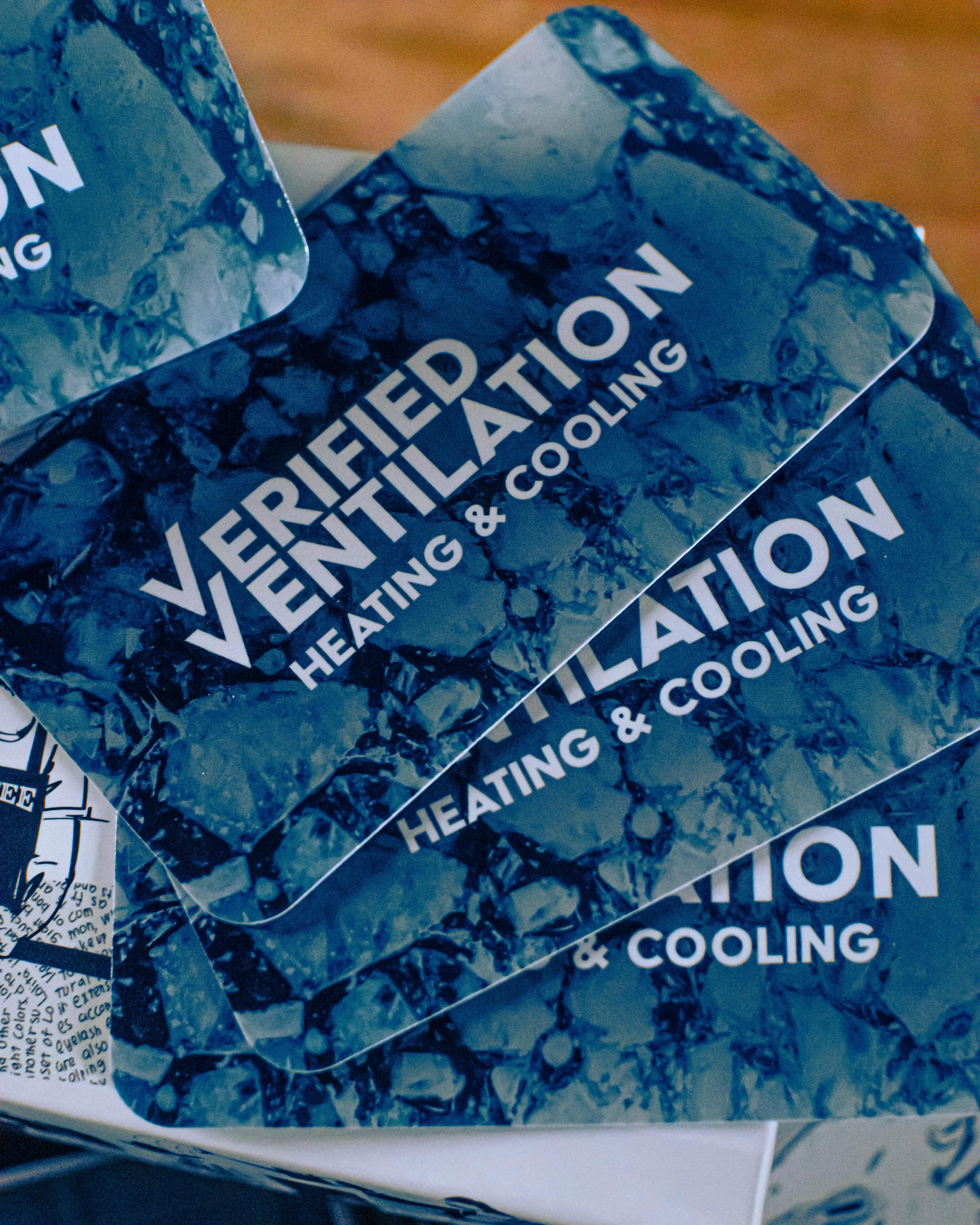 An image of three Verified Ventilation business cards stacked on top of each other.