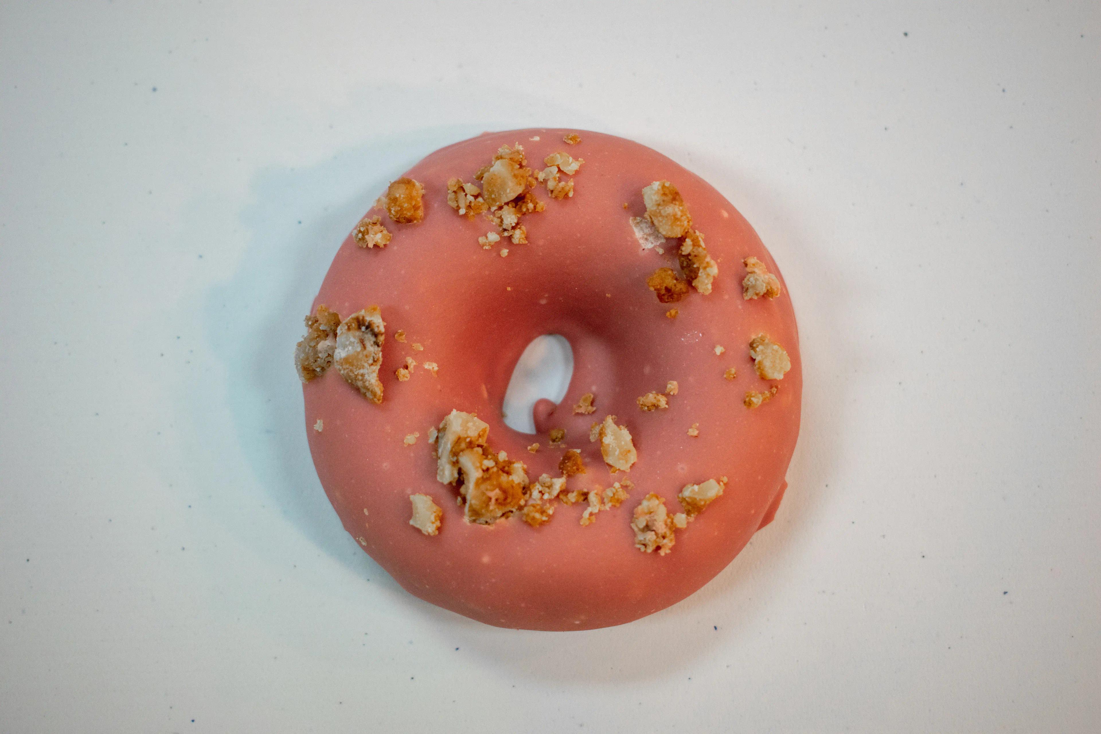 A top-down photo of Rotten Apples Canna Co.'s Maple Covered Bourbon Donut.